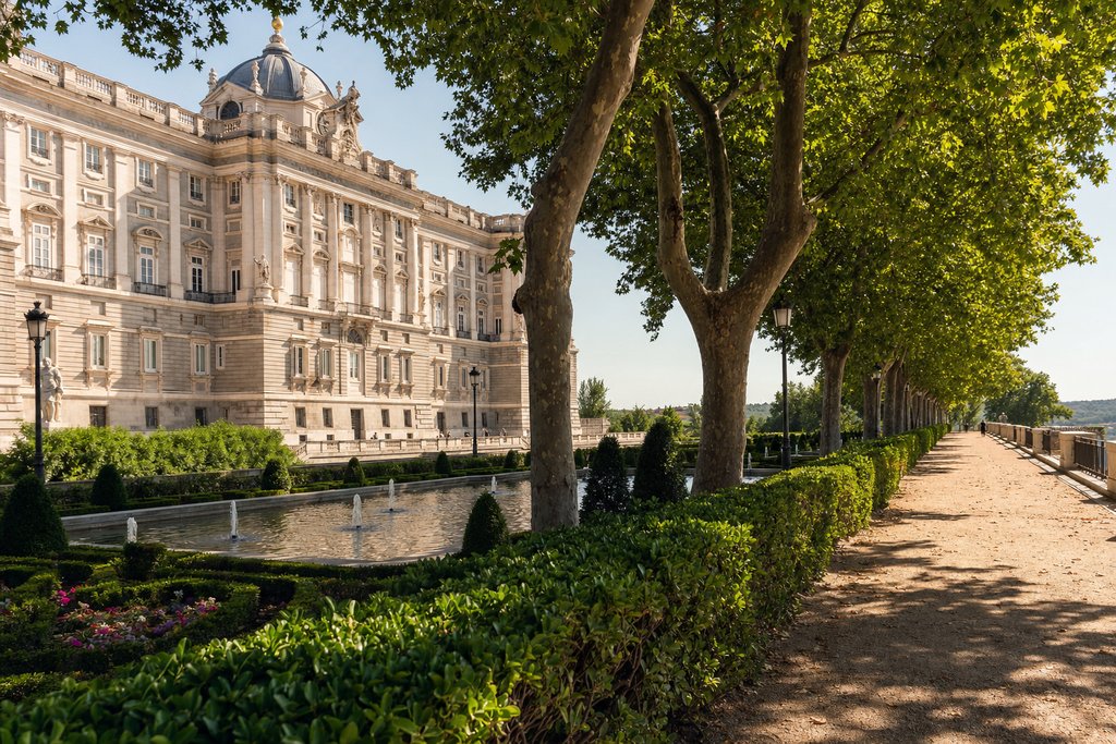 Formal Spanish royal palace gardens with tree-lined promenades